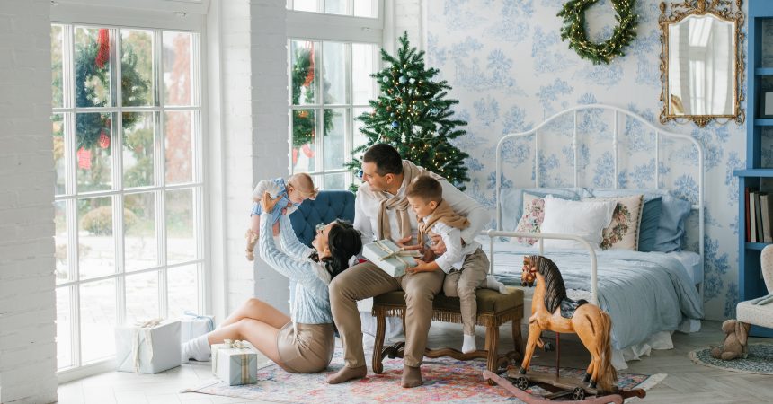 Happy Family Playing With Children In Festive Christmas Interior