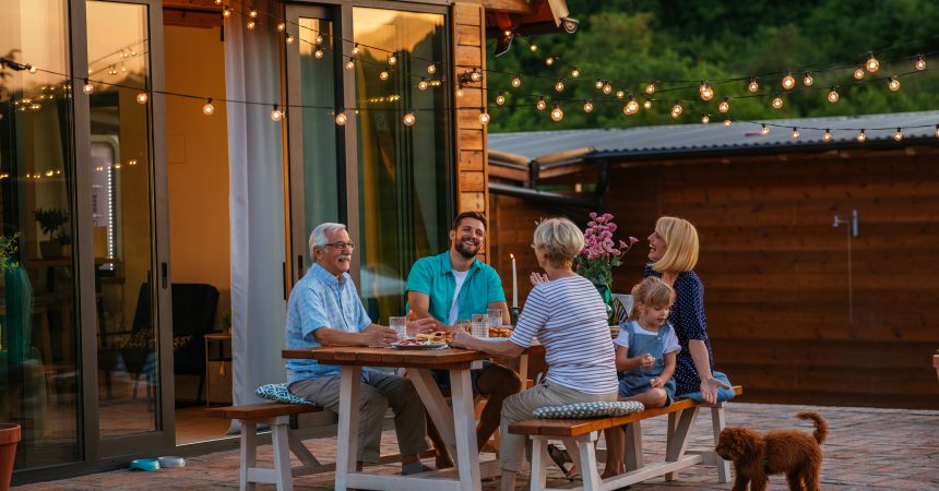 Family dinner around dining table in the garden